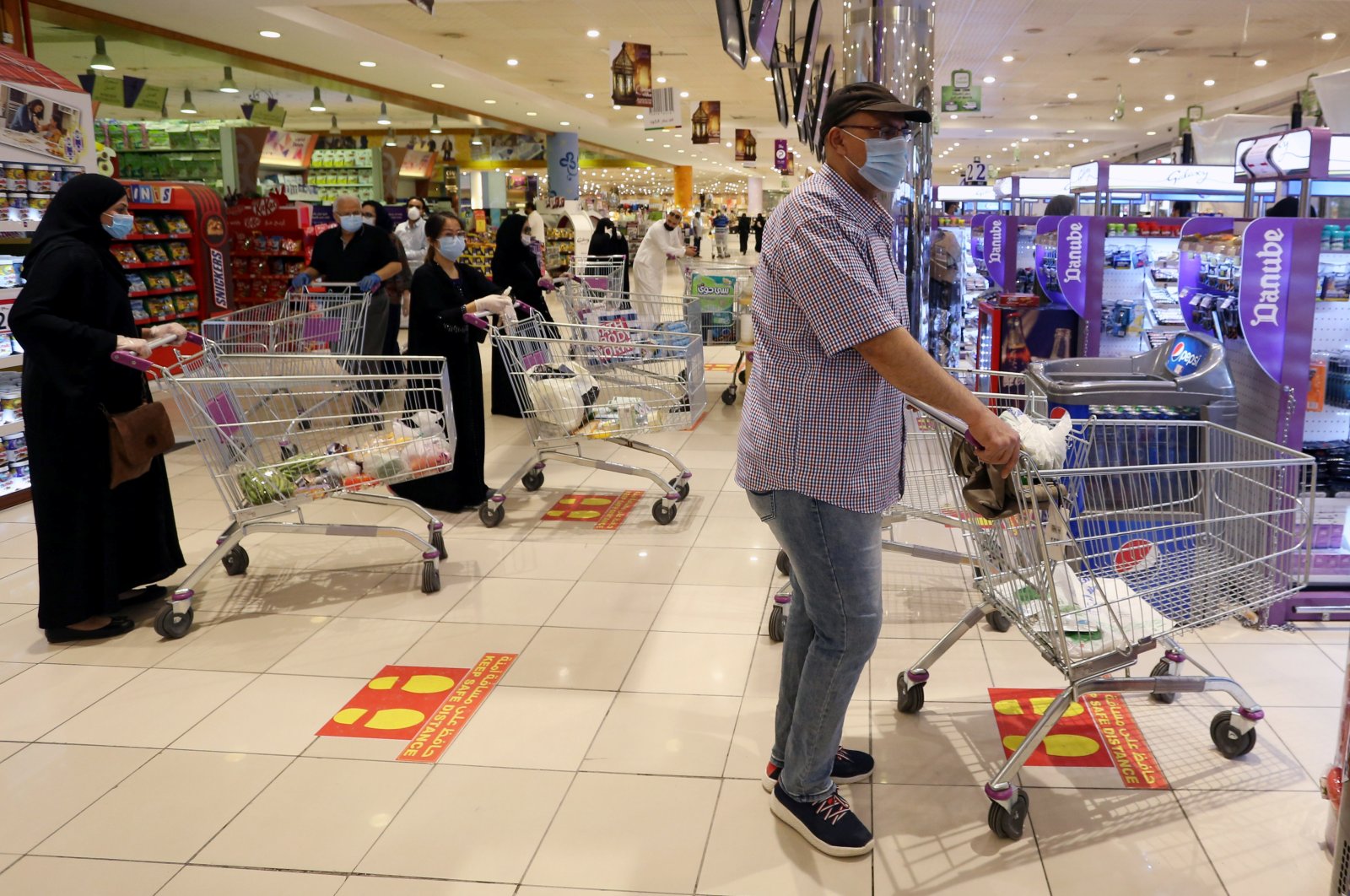 People follow social distancing markings as they line up at a shopping mall in Riyadh, Saudi Arabia, May 2, 2020. (Reuters Photo)