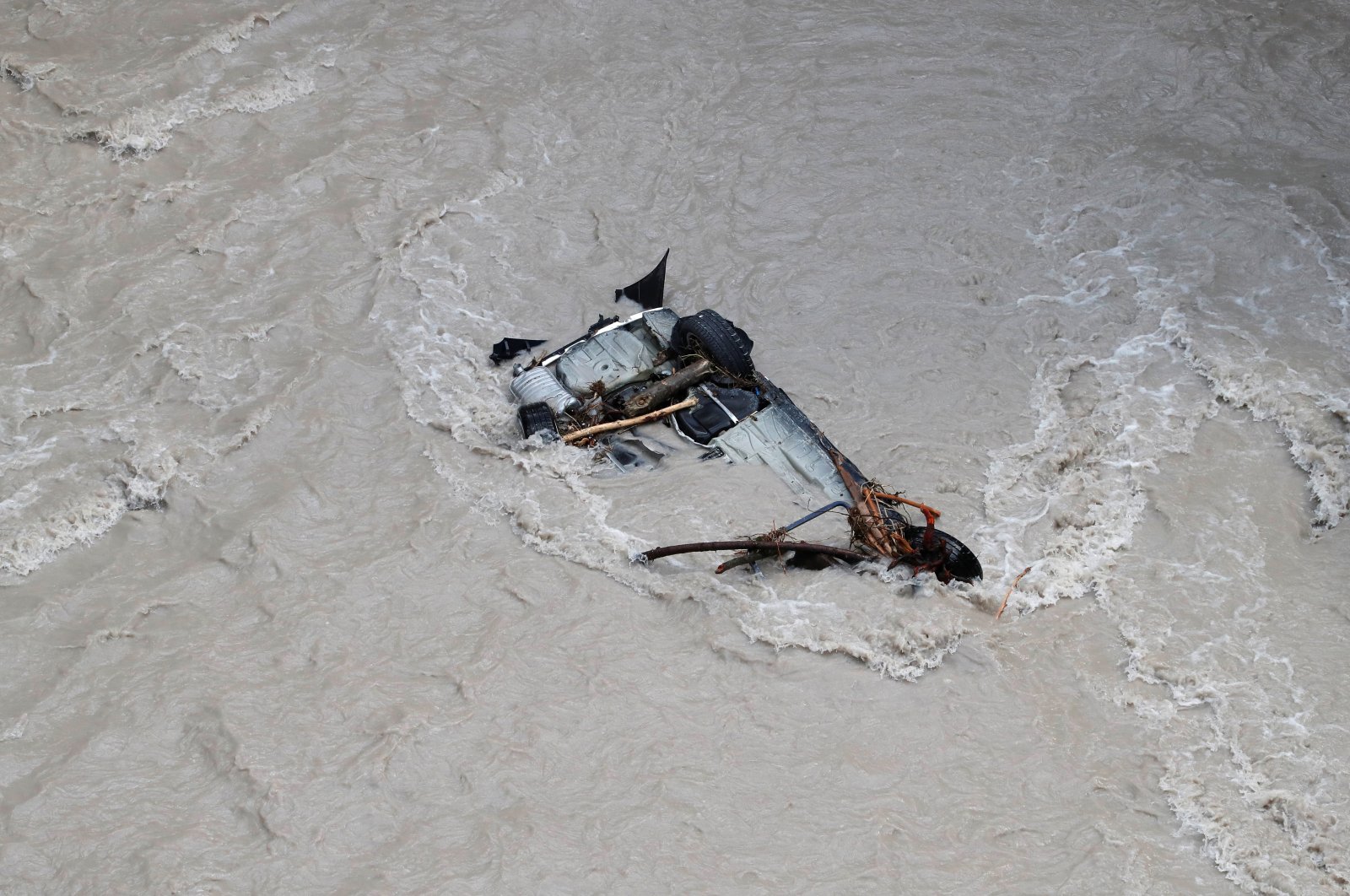 A damaged car is seen in the Roya river in Breil-sur-Roya as clean-up operations continue after storm Alex hit southern France, bringing record rainfall in places and causing heavy flooding that swept away roads and damaged homes, France, Oct. 5, 2020. (Reuters Photo)