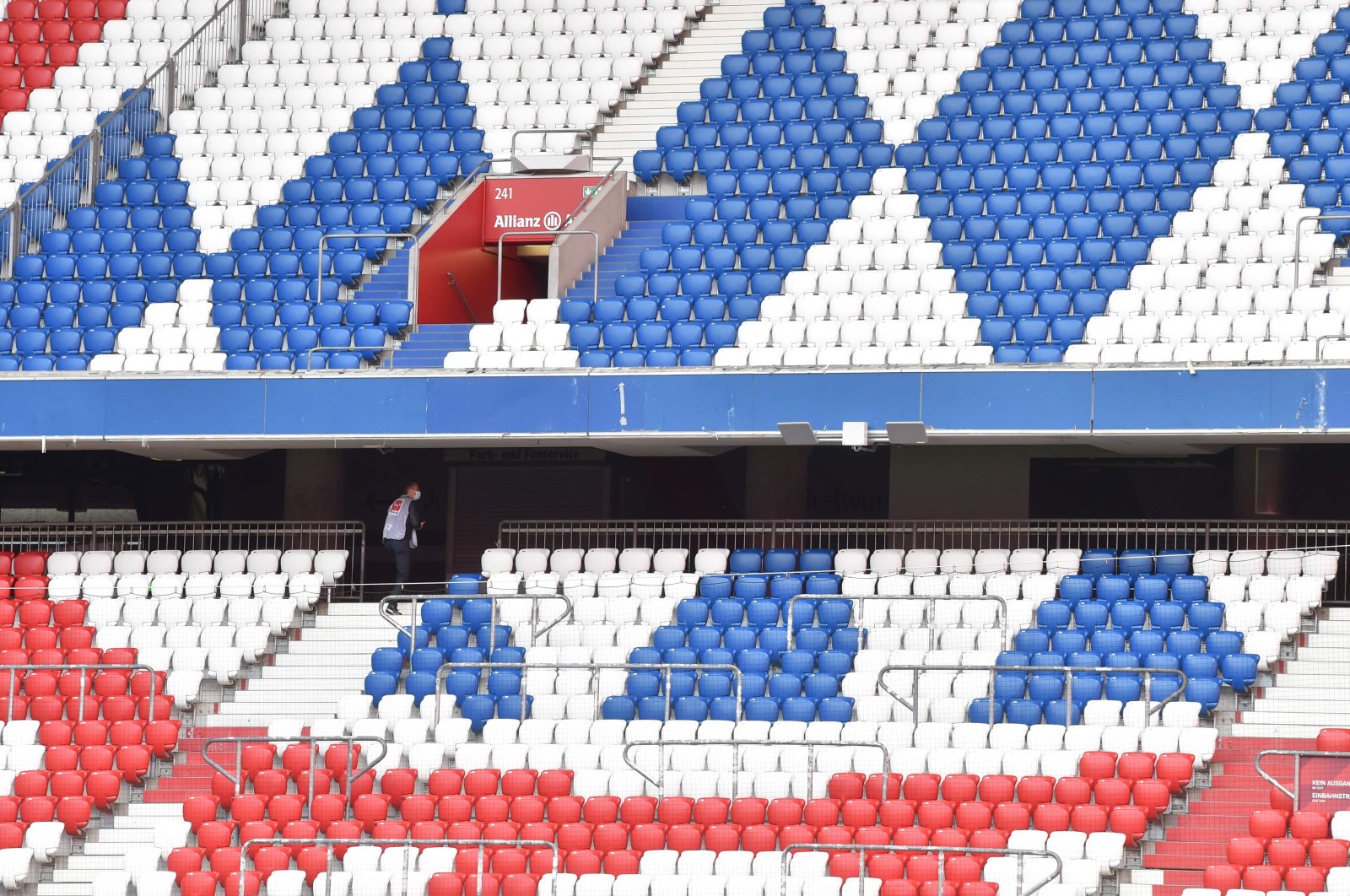 A staff member is seen in the empty stands prior to a Bundesliga football match between FC Bayern Munich and Hertha Berlin at Allianz Arena in Munich, Germany, Oct. 4, 2020. (AFP Photo)