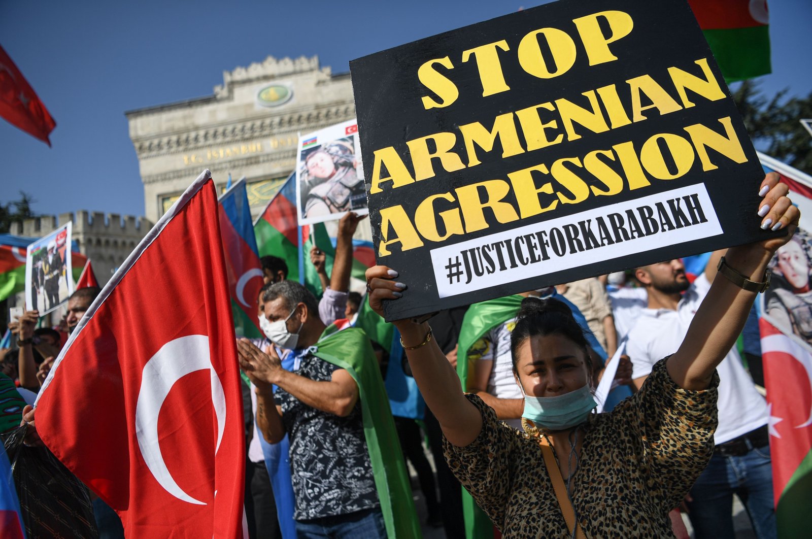 An Azerbaijani protester holds up a sign as she takes part in a demonstration in Istanbul, Turkey, Oct. 4, 2020. (AFP Photo)