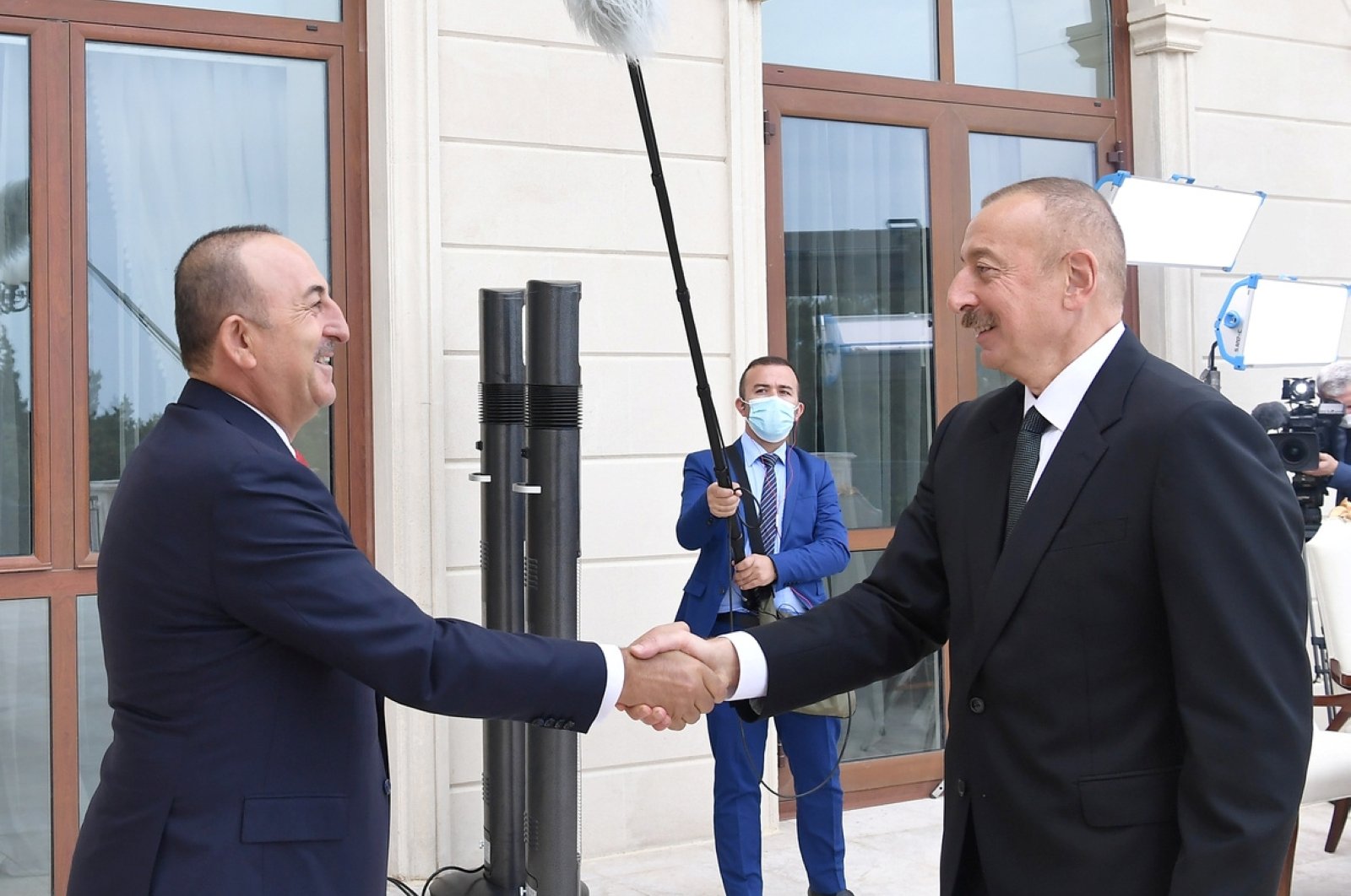 Azerbaijan's President Ilham Aliyev (R) shakes hands with Turkey's Foreign Minister Mevlüt Çavuşoğlu during a meeting in Baku, Oct. 6, 2020. (REUTERS)