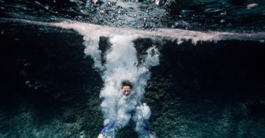 A woman free-dives in the clear waters of Suluada at Cape Gelidonya in Antalya, Turkey, Oct. 5, 2020. (AA Photo)