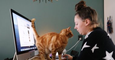 A woman works in a house while workers are forced to work from home and demand payback for extra home office costs during the coronavirus pandemic in Sassenheim, Netherlands, Oct. 2, 2020. (Reuters Photo)