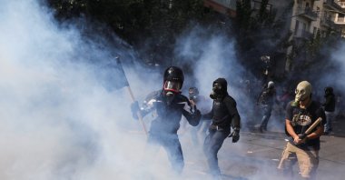 Protesters are seen among tear gas during clashes outside a court, Athens, Oct. 7, 2020. (REUTERS Photo)