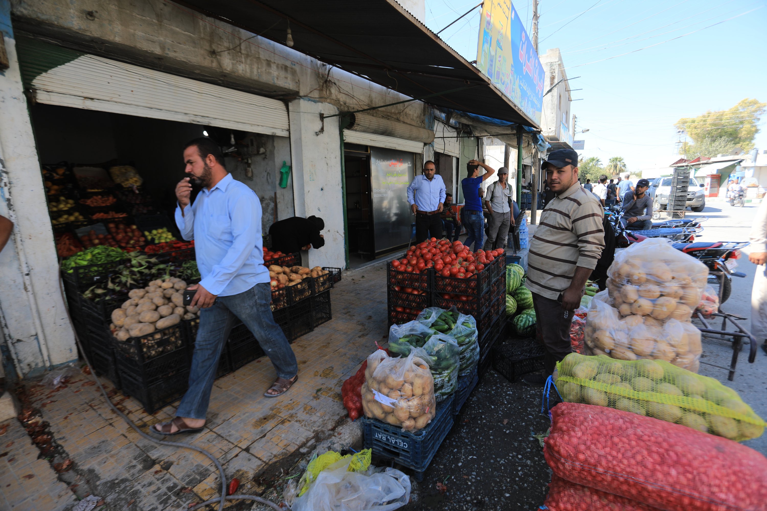 People walk through the bazaar in central Tal Abyad, Syria, Oct. 8, 2020. (AA Photo)