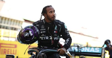 Lewis Hamilton steps out of his car after winning the Formula 1 Tuscany Grand Prix, in Scarperie, Italy, Sept. 13, 2020. (AP Photo) 