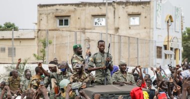 Armed members are celebrated by the population as they parade at Independence Square, Bamako, Mali, Aug. 18, 2020. (AFP Photo)