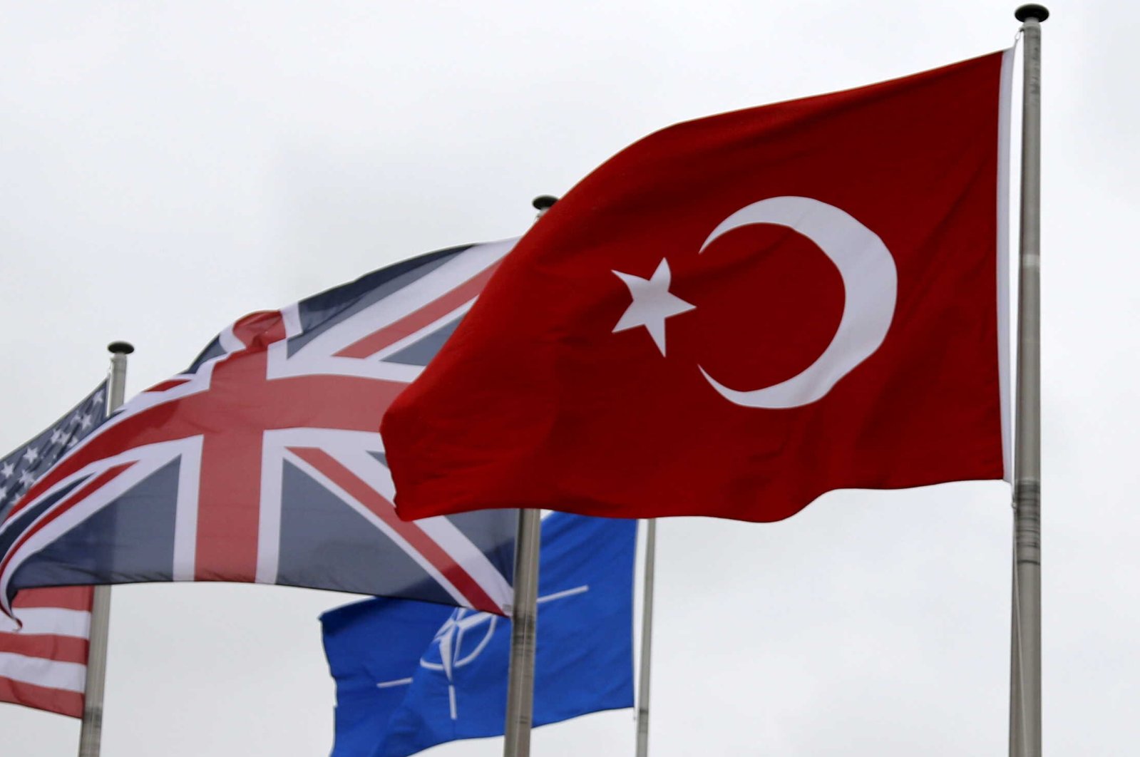 A Turkish flag (R) flies near the flags of the U.K. and other NATO members during the North Atlantic Council (NAC) meeting upon Turkey's request for Article 4 consultations, at NATO headquarters in Brussels, Belgium, July 28, 2015. (Reuters Photo)