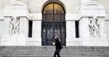 A woman passes the Italian Stock Exchange in Milan, Italy, Feb. 25, 2020. (Reuters Photo)