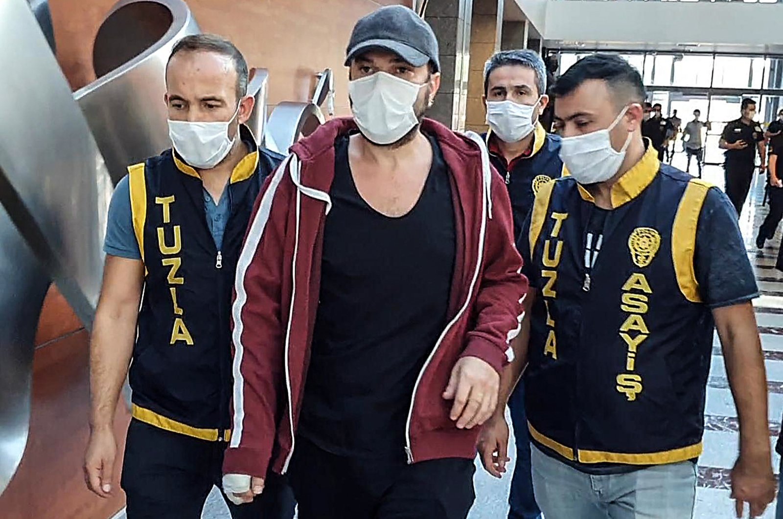 Police escort Halil Sezai Paracıkoğlu (C) to the courthouse in Istanbul, Turkey, Sept. 17, 2020. (AA Photo) 