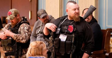 William Null (R), one of suspected kidnappers, stands in the gallery of the Michigan Senate Chamber during the American Patriot Rally, organized by Michigan United for Liberty, to demand the reopening of businesses on the steps of the Michigan State Capitol in Lansing, Michigan, on April 30, 2020. (AFP Photo)