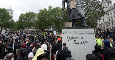 The statue of former British prime minister Winston Churchill is seen defaced, with the words (Churchill) "was a racist" written on it's base in Parliament Square, central London after a demonstration outside the US Embassy, on June 7, 2020. (AFP Photo)