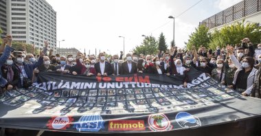 A group holds a banner showing the victims of the 2015 suicide attacks during a commemoration ceremony in the capital Ankara, on Oct. 10, 2020. (AA Photo)