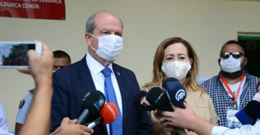Turkish Republic of Northern Cyprus (TRNC) Prime Minister and the presidential candidate of the National Unity Party (UBP) Ersin Tatar (L) speaks to reporters after casting his ballot with his wife Sibel Tatar at the Şehit Tuncer Elementary School in Lefkoşa (Nicosia), TRNC, Oct. 11, 2020. (AA photo)