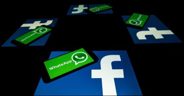 The logo of U.S. social network Facebook and mobile messaging service WhatsApp on the screens of a smartphone and a tablet in Toulouse, southwestern France on Oct. 5, 2020. (AFP Photo)