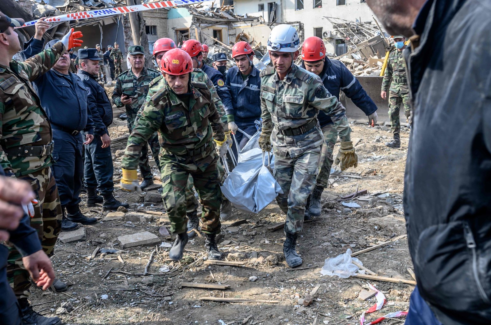 Rescuers carry away the body of an Azerbaijani victim at the blast site hit by an Armenian rocket in the city of Ganja, Azerbaijan, Oct. 11, 2020. (AFP)
