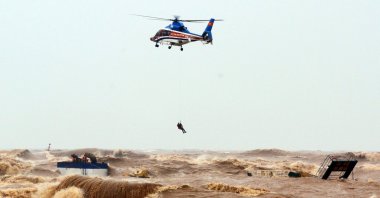 A Thai Defense Ministry helicopter rescue stranded crew members at the sea, in Quang Tri province, Vietnam, Oct. 11, 2020. (EPA-EFE Photo)