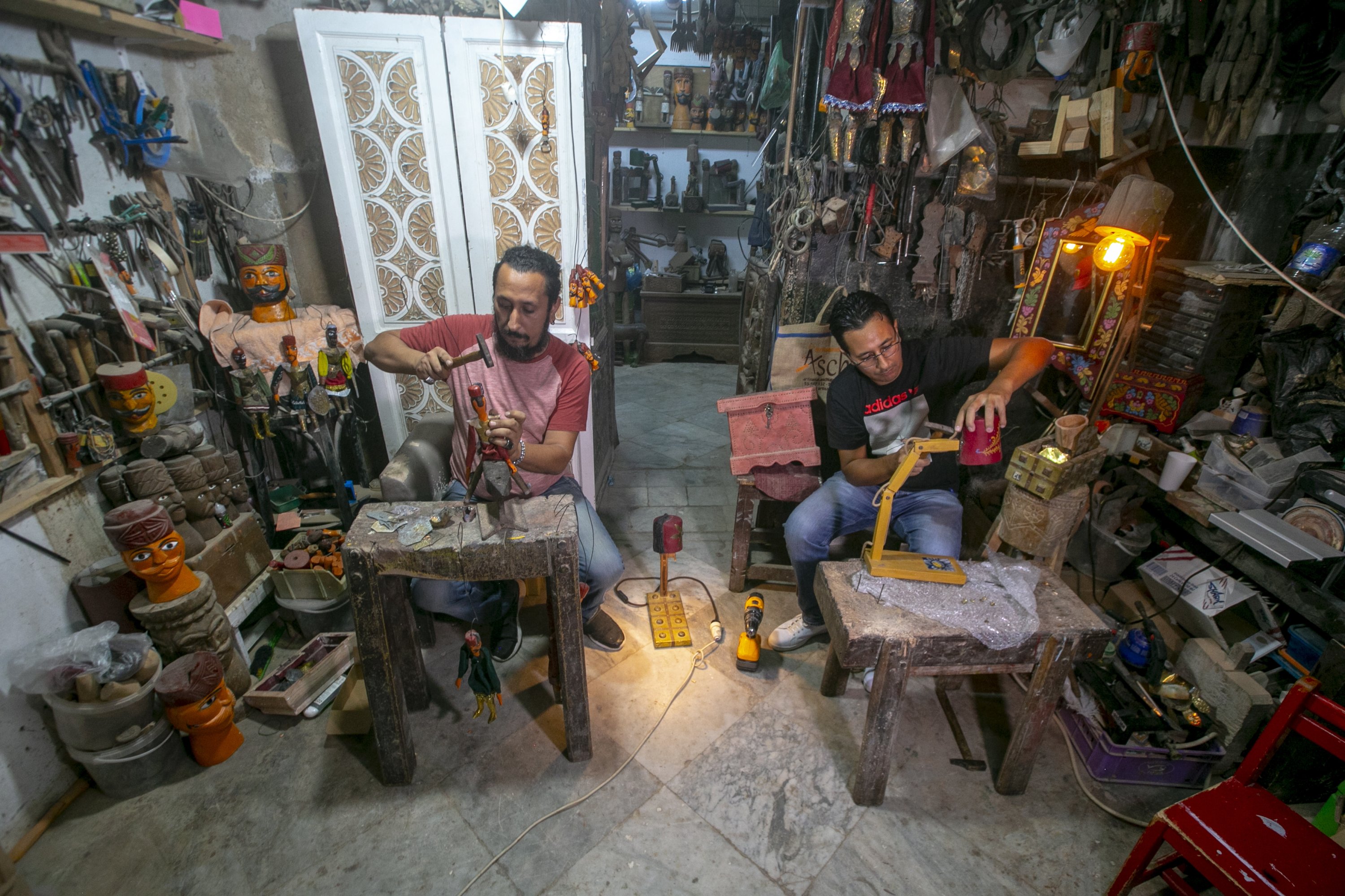 Tunisian brothers Adel and Ismail el-Ashi make puppets in their workshop in the capital Tunis, Tunisia, Oct. 10, 2020. (AA Photo)