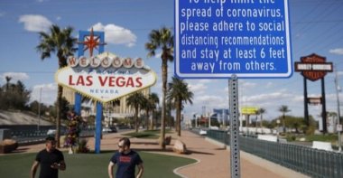 A sign advises people to practice social distancing to slow the spread of the coronavirus at the "Welcome to Fabulous Las Vegas Nevada" sign amid a shutdown of casinos along the Las Vegas Strip in Las Vegas, Nevada, U.S., March 21, 2020. (AP Photo)