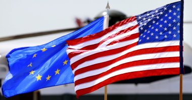 The U.S. and European Union flags wave as members of the EU Delegation arrive to attend the G-8 Summit, at Dulles International Airport in Chantilly, Virginia, May 18, 2012. (AP Photo)