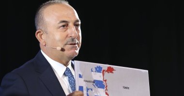 Foreign Minister Mevlüt Çavuşoğlu shows the Seville Map, which represents Greece and the Greek Cypriot administration's maximalist claims in the Eastern Mediterranean, as he speaks during a conference in Bratislava, Slovakia, Oct. 8, 2020. (AP Photo)