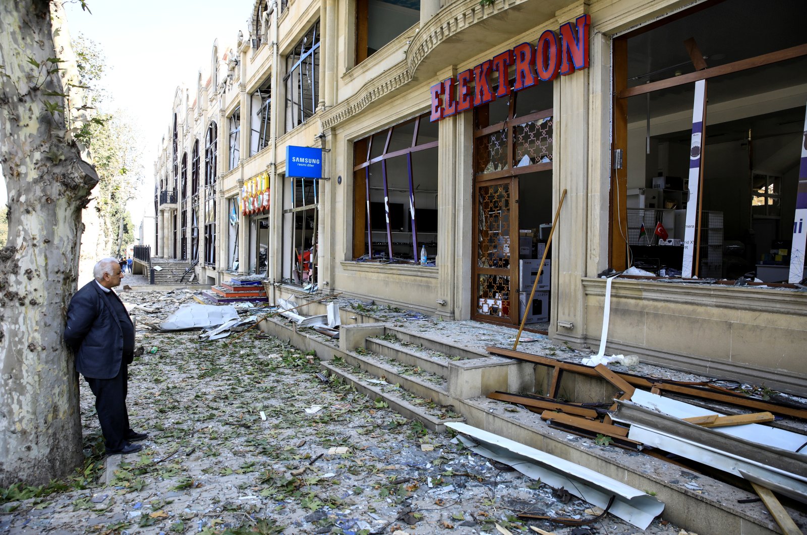A shop owner stands in front of his store at a blast site from an Armenian rocket in the city of Ganja, Azerbaijan, Oct. 11, 2020. (Reuters Photo)