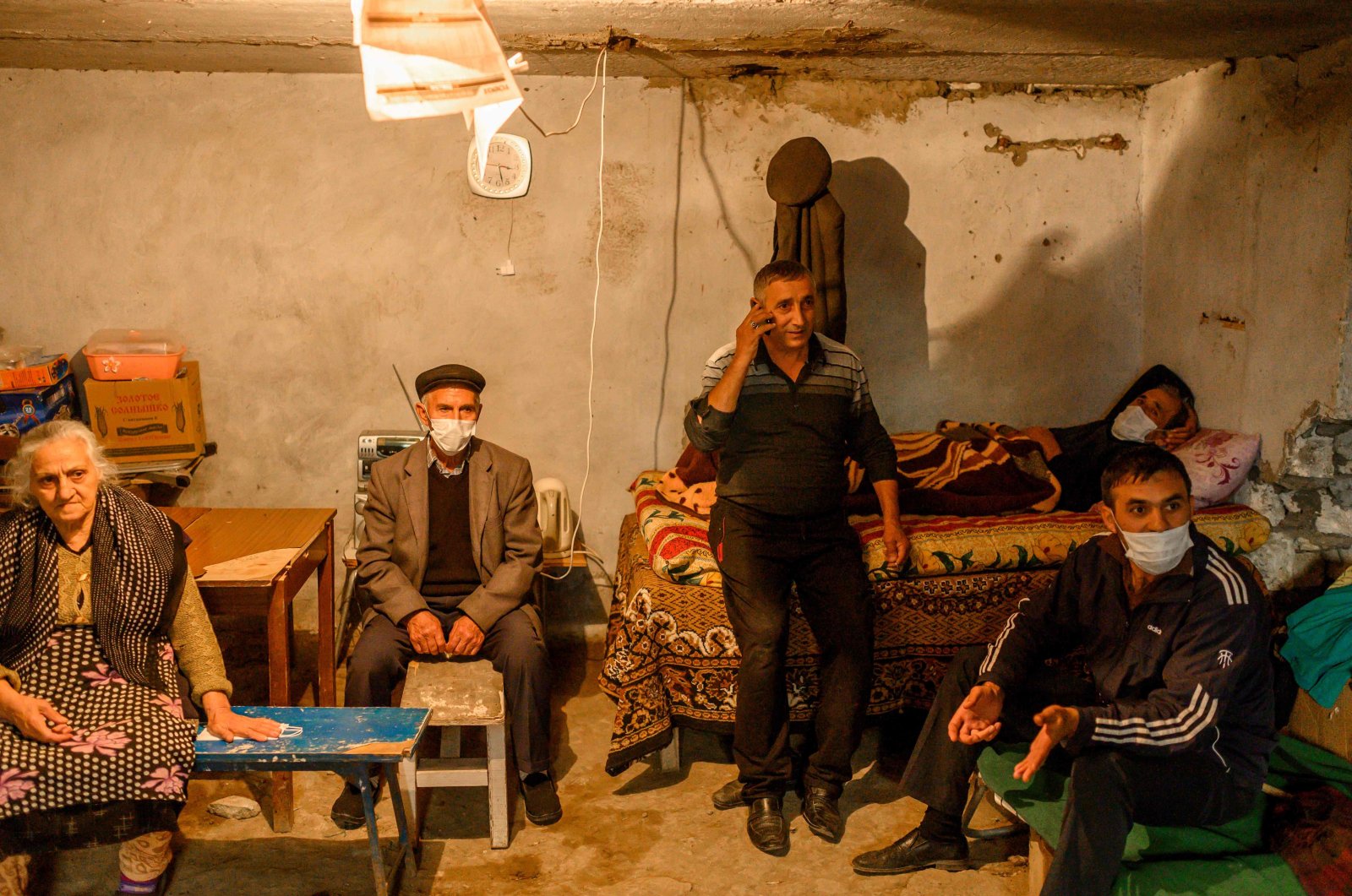 People shelter from Armenian shelling in a basement of a building in the city of Tartar, Azerbaijan, on Oct. 13, 2020, during the ongoing military conflict over Azerbaijan's illegally occupied region of Nagorno-Karabakh. (AFP Photo)
