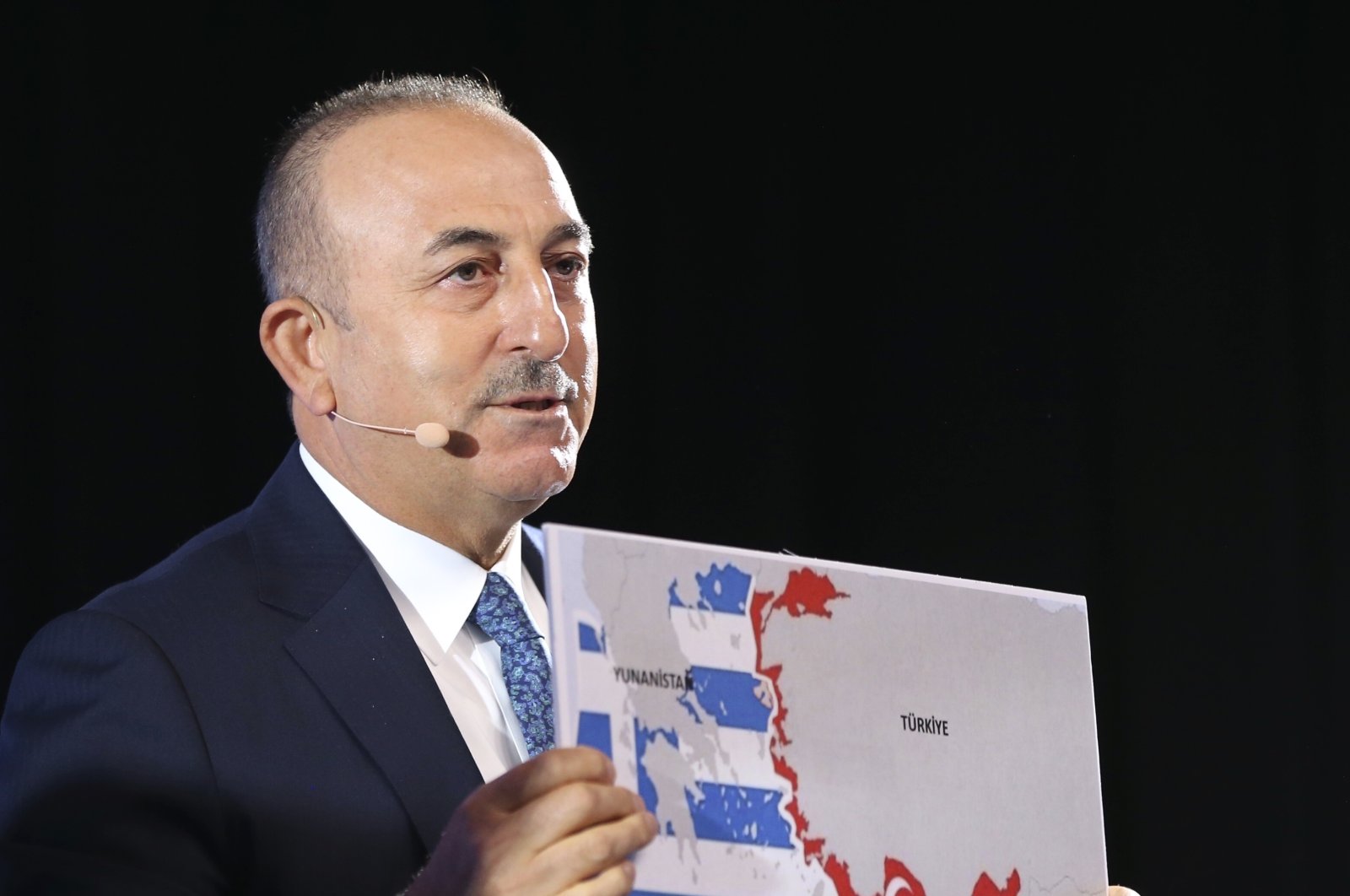 Foreign Minister Mevlüt Çavuşoğlu shows the Seville Map, which represents Greece and the Greek Cypriot administration's maximalist claims in the Eastern Mediterranean, as he speaks during a conference in Bratislava, Slovakia, Oct. 8, 2020. (AP Photo)