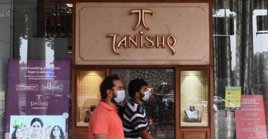 Men walk past a Tanishq jewelry showroom in a shopping arcade in New Delhi, India, Oct. 14, 2020. (AFP Photo)