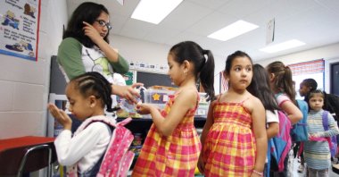 Children are given hand sanitizer before going to lunch at a summer school program in Montgomery County's Brookhaven Elementary School, in Rockville, Maryland, July 29, 2009. (AP Photo)