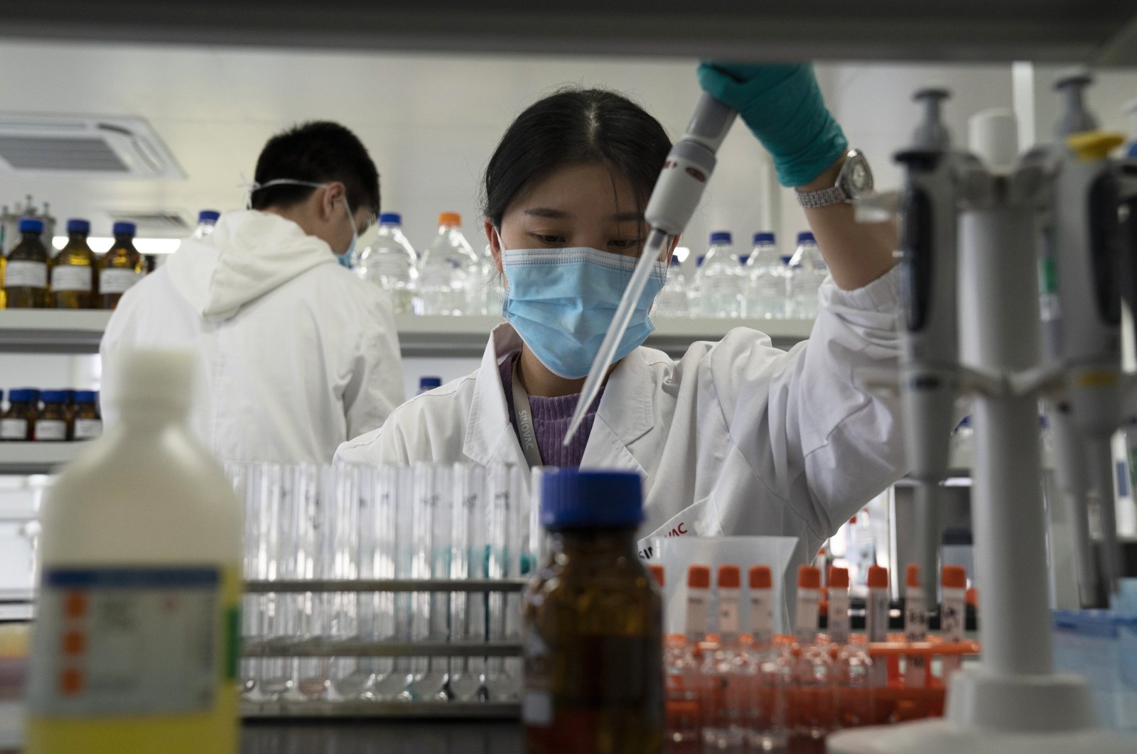 An employee of SinoVac works in a lab at a factory producing its SARS-CoV-2 vaccine for COVID-19 named CoronaVac in Beijing, China, Sept. 24, 2020. (AP Photo)