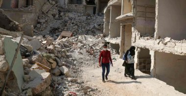 Two Syrian medics go door to door in the ravaged town of Ariha in the opposition-held northwestern Idlib province, Syria, Oct. 10, 2020. (AFP Photo)