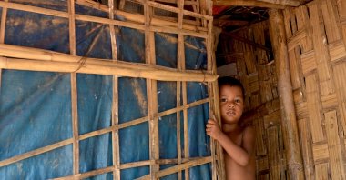 A Rohingya refugee child peeps out from his hut in Kutupalong refugee camp in Ukhia on Oc. 11, 2020. (AFP Photo)