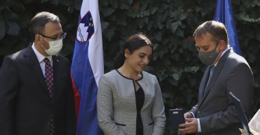 Slovenia's Ambassador Primoz Seligo (R) presents an award to Sıla Kara (C) at a ceremony, in the capital Ankara, Turkey, Oct. 15, 2020. (İHA Photo)