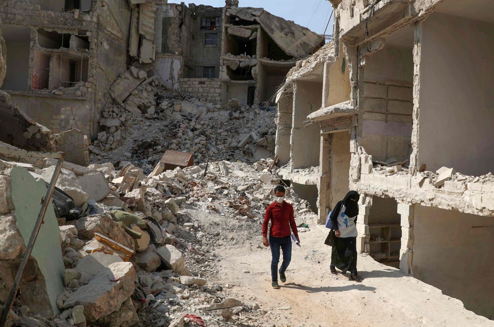 Two Syrian medics go door to door in the ravaged town of Ariha in the opposition-held northwestern Idlib province, Syria, Oct. 10, 2020. (AFP Photo)
