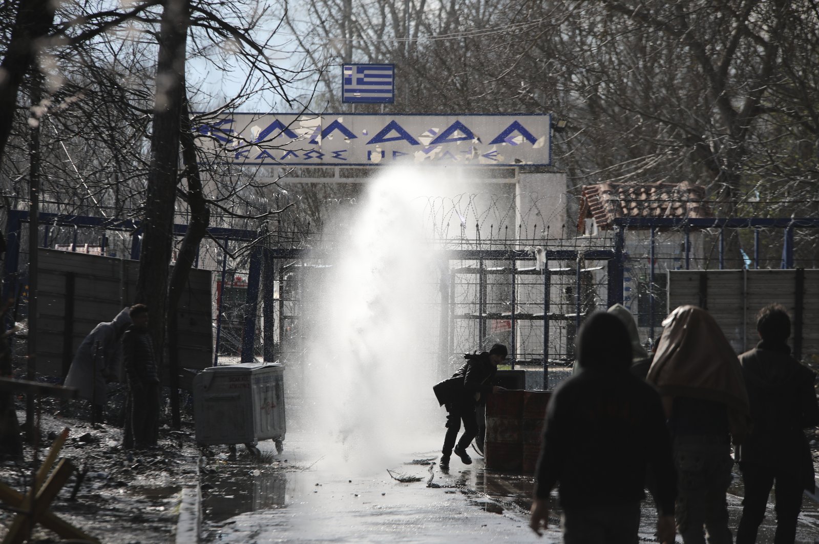 Greek security forces use tear gas against migrants at the Turkish-Greek border in Pazarkule, Edirne region, Turkey, March 11, 2020. (AP Photo)
