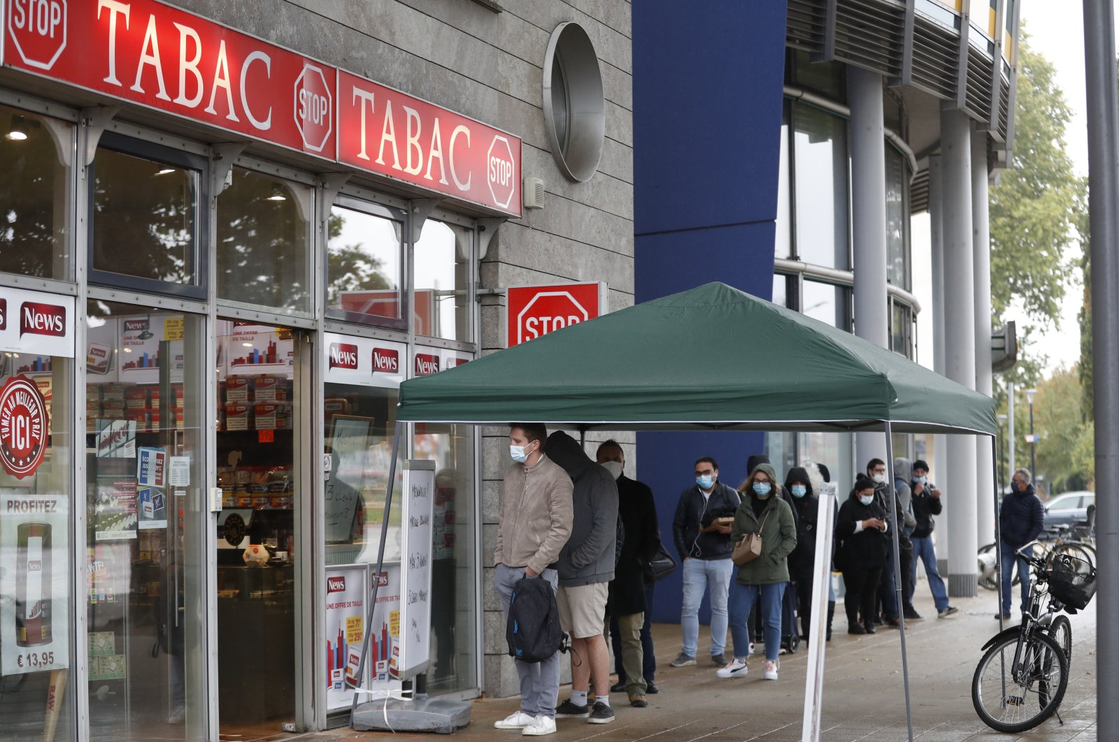 French citizen queue to buy cigarettes in Kehl, Germany, at the German-French border, Oct. 15, 2020. (AP Photo)
