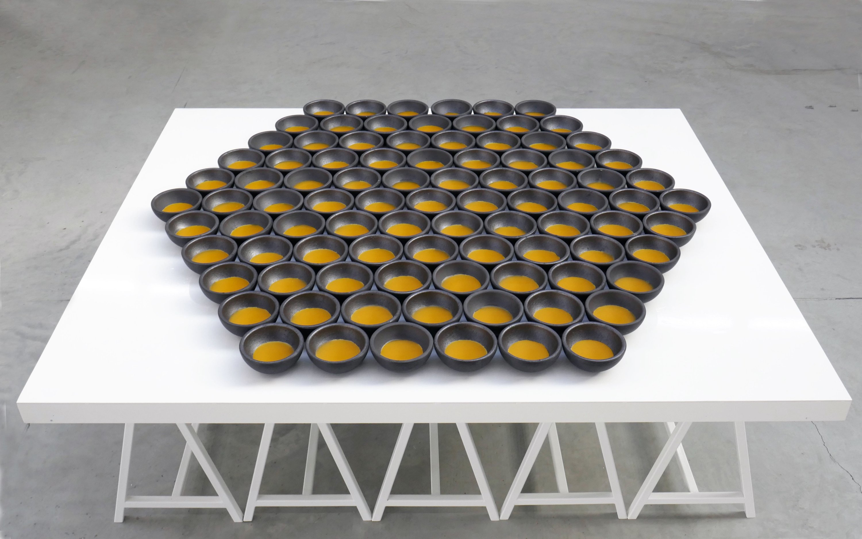 Osman Dinç, "Elbow Grease of Bee," installation with aluminum and wax, the diameter of each piece is 12 centimeters.