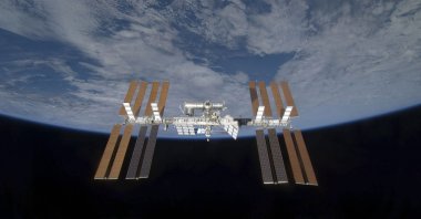 Backdropped by the blackness of space and Earth's horizon, the International Space Station is seen from space shuttle Discovery as the two spacecraft begin their relative separation, March 25, 2009. (Reuters Photo)