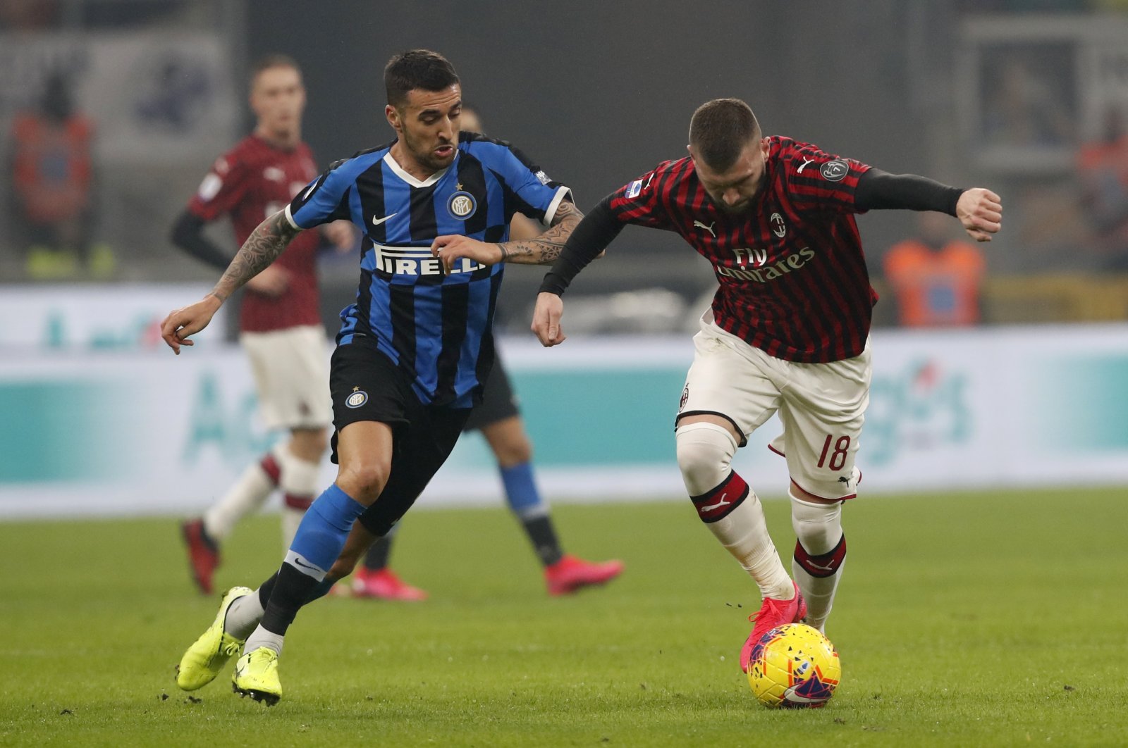 AC Milan's Ante Rebic (R) controls the ball past Inter Milan's Matias Vecino during a Serie A match, in Milan, Italy, Feb. 9, 2020. (AP Photo)