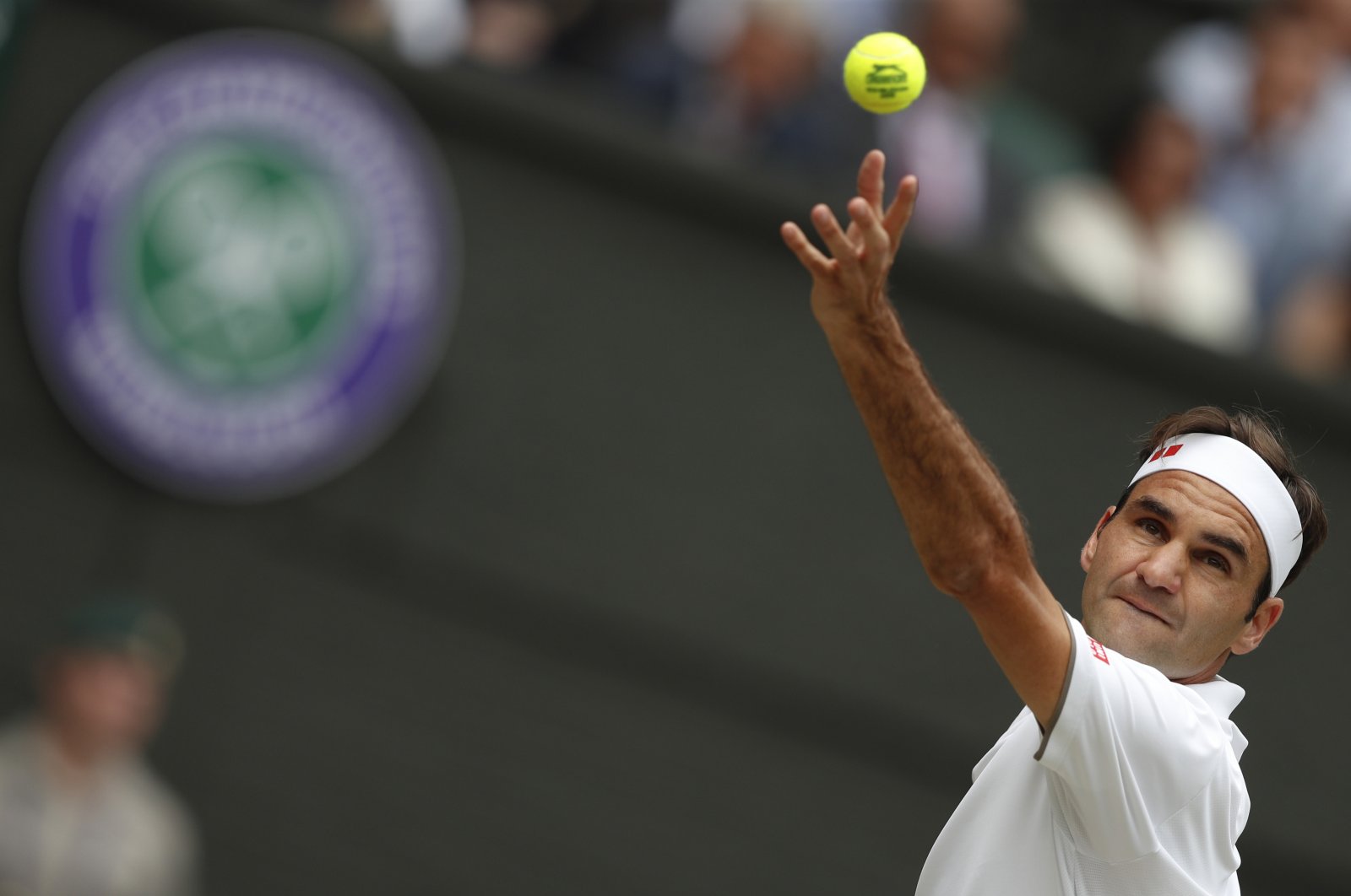 Roger Federer serves to Novak Djokovic during a Wimbledon tennis tournament final, in London, Britain, July 14, 2019. (AP Photo)