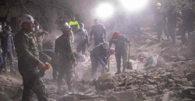 Rescue teams work at a site hit by an Armenian rocket amid Azerbaijani military operation to liberate Armenian-occupied Nagorno-Karabakh region, in Ganja, Azerbaijan, Oct. 17, 2020. (AFP Photo)