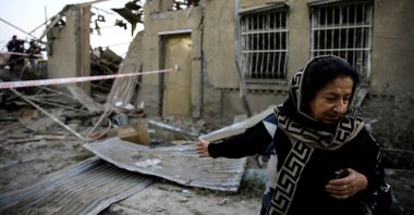 Hicran Quliyeva reacts as she stands in front of her house at a blast site hit by a rocket during the fighting over the illegally occupied region of Nagorno-Karabakh, in the city of Ganja, Azerbaijan, Oct. 17, 2020. (Reuters Photo)