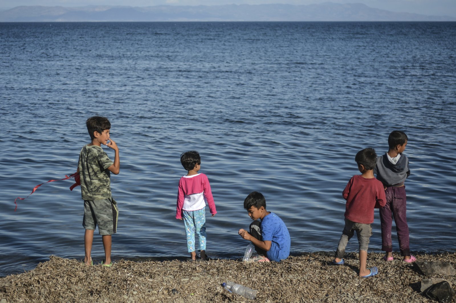 Children stand by the sea at the Kara Tepe refugee camp, on the northeastern Aegean island of Lesbos, Greece, Wednesday, Oct. 14, 2020. (AP Photo)