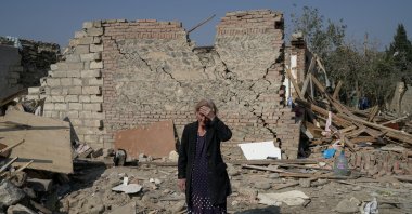 Regibe Guluyeva, 67, stands in the ruins of her home, which was hit by a rocket, in the city of Ganja, Azerbaijan, Oct. 18, 2020. (Reuters Photo)