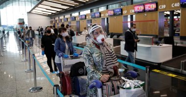 Passengers wearing face masks stand in a queue at the Istanbul Airport, June 1, 2020. (REUTERS Photo)