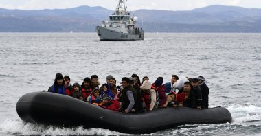 Migrants arrive with a dinghy accompanied by a Frontex vessel at the village of Skala Sikaminias, on the Greek island of Lesbos, after crossing the Aegean Sea from Turkey, on Feb. 28, 2020. (AP Photo)