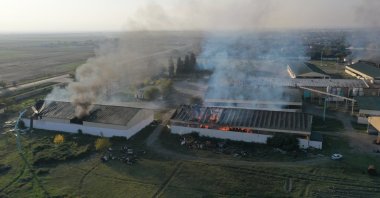 A cotton factory burns following Armenian artillery fire despite a cease-fire agreement between Baku and Yerevan, in a village in the Azerbaijani city of Tartar, Oct. 19, 2020. (AA Photo)