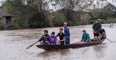 Local residents row a boat to a pickup point for delivering aid packages to residents affected by heavy flooding in Quang An Commune, Thua Thien Hue, Vietnam, Oct. 20, 2020. (Reuters Photo)