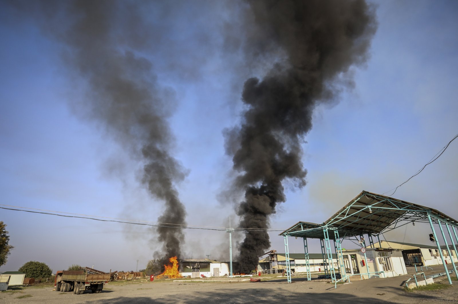 A view of a fire on the grounds of a local factory following recent shelling during fighting over the Armenian occupied region of Nagorno-Karabakh, in Tartar, Azerbaijan, Oct. 19, 2020. (AP Photo)